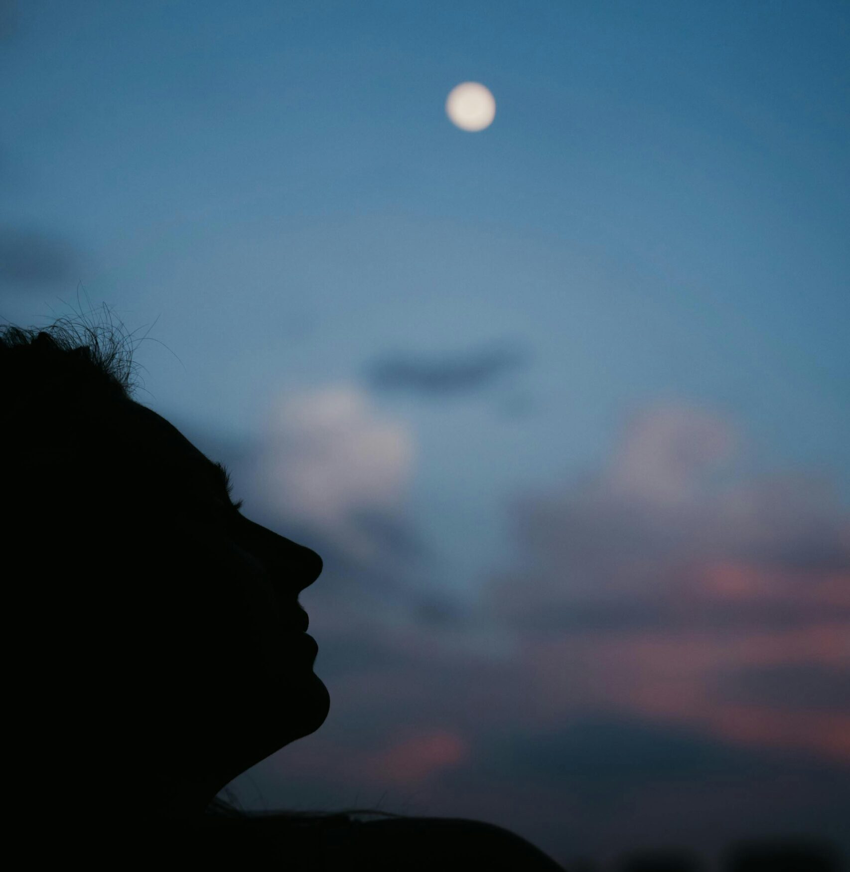 face shadow looking at the moon at night