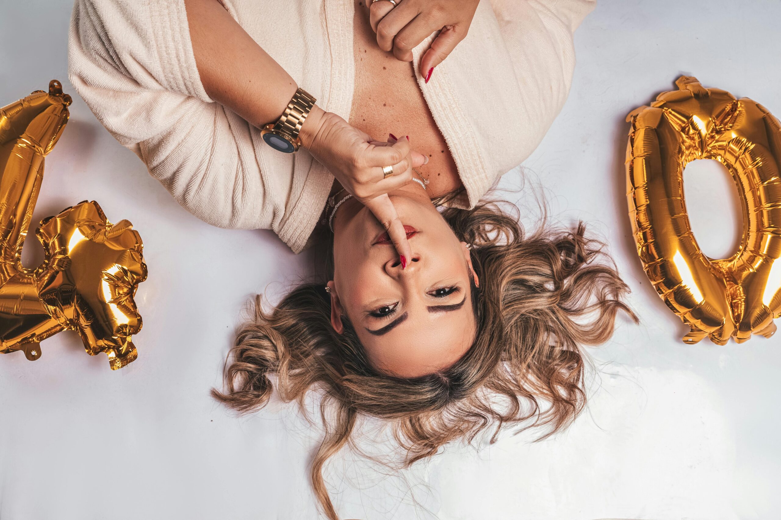 woman over forty lay down in a white sheet