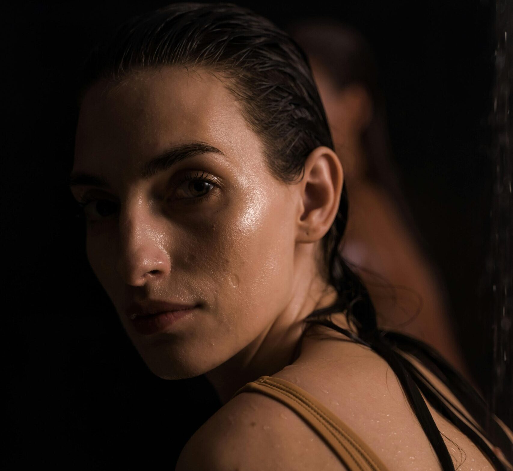 girl in a shadowed light looking at the camera